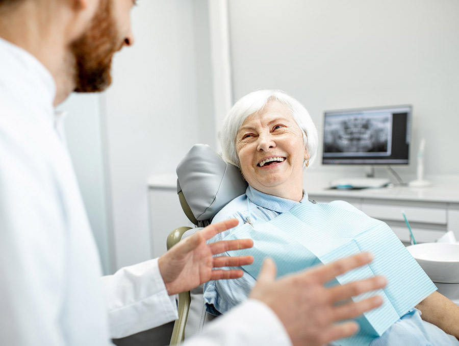I Love My Dentist | dentist consulting with smiling patient